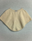Beige knitted poncho on a gray background