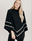Woman wearing a charcoal Merinosilk Stripe Poncho  with black pants