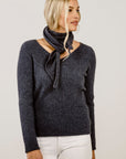 Woman wearing a grey top and a matching scarf