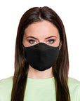 Woman wearing a black travel mask with adjustable elastic straps, made from merino soft & comfort next to skin, with a label showing 'Made in New Zealand', and highlighting features such as 100% breathable, adjustable elastic straps, and a machine washable filter.