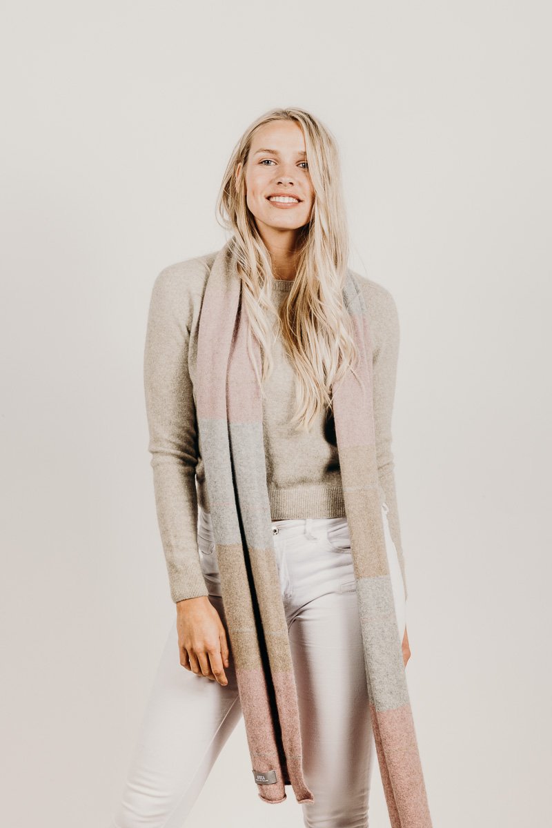 A woman wearing a Kapeka town scarf merino silk blushpink