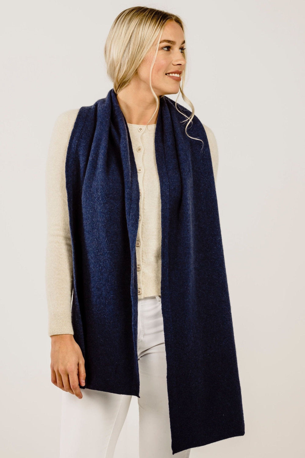 Woman wearing a navy blue scarf on a white background