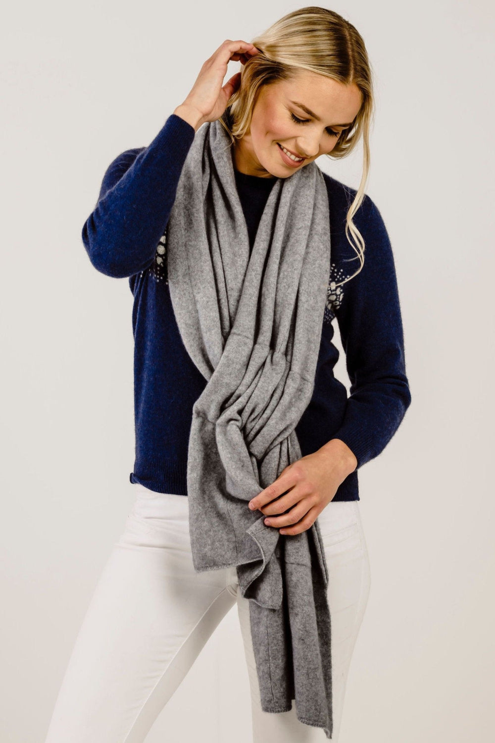 Woman wearing a gray scarf with a white background