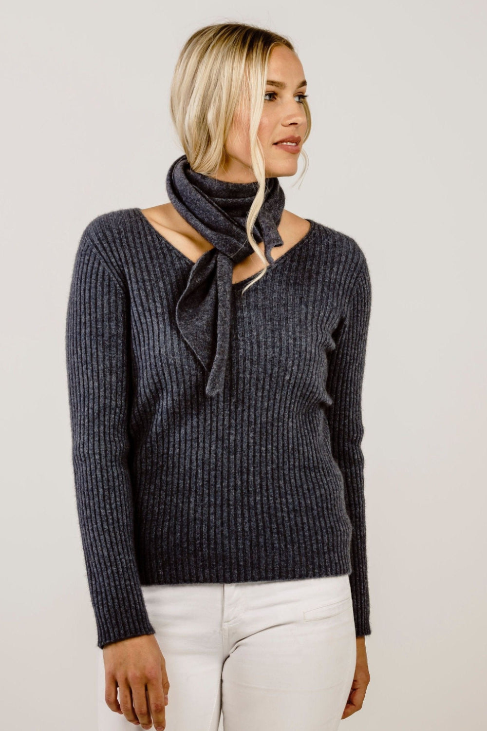 Woman wearing a grey top and a  matching scarf