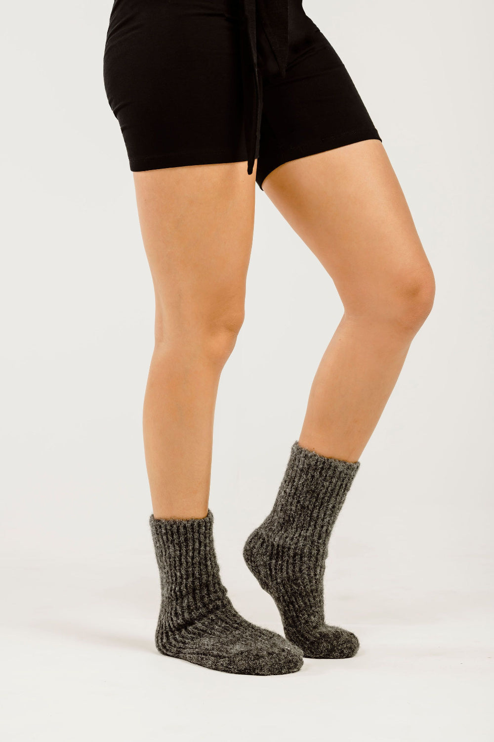 Women&#39;s legs with grey socks