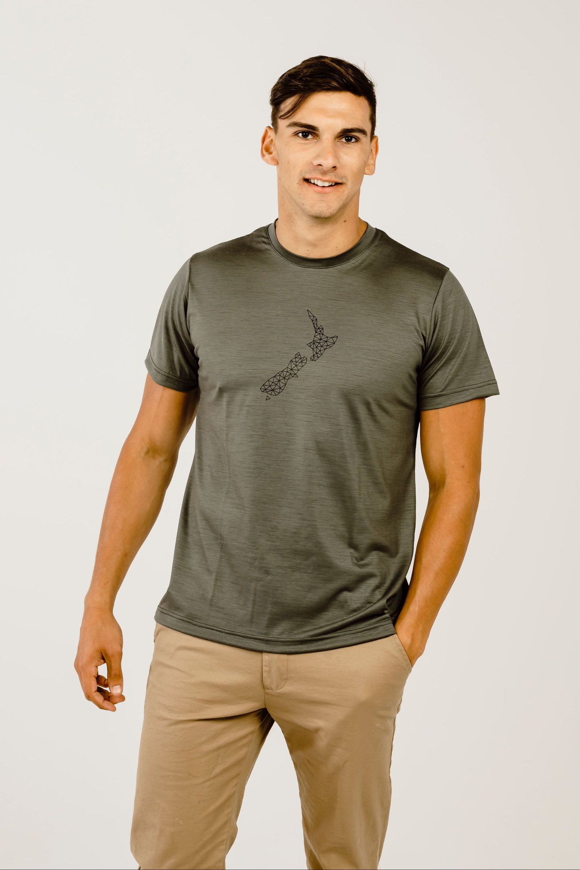 Man wearing a green t-shirt with a logo on a white background