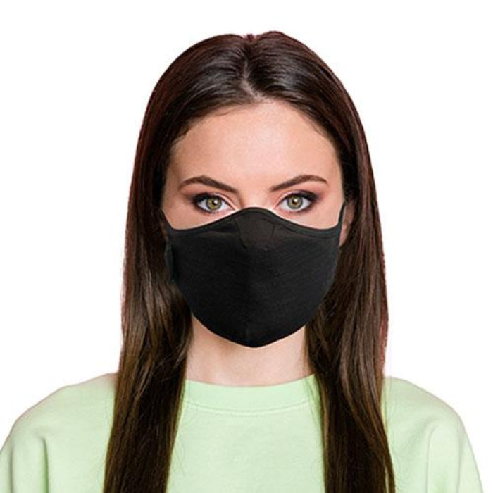 Woman wearing a black travel mask with adjustable elastic straps, made from merino soft & comfort next to skin, with a label showing 'Made in New Zealand', and highlighting features such as 100% breathable, adjustable elastic straps, and a machine washable filter.