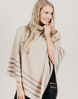 Woman wearing a　Lichen Merinosilk Stripe Poncho with black pants